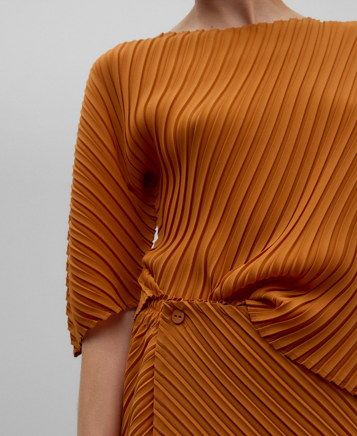 Asymmetrical crinkle top woman in orange