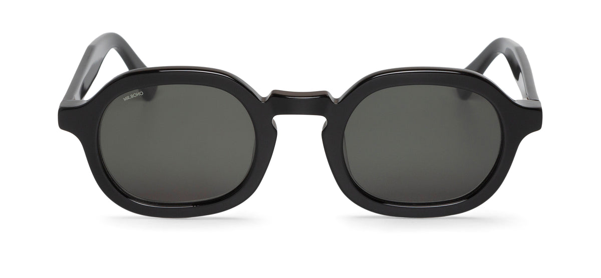 A pair of black framed oval sunglasses with dark lenses.