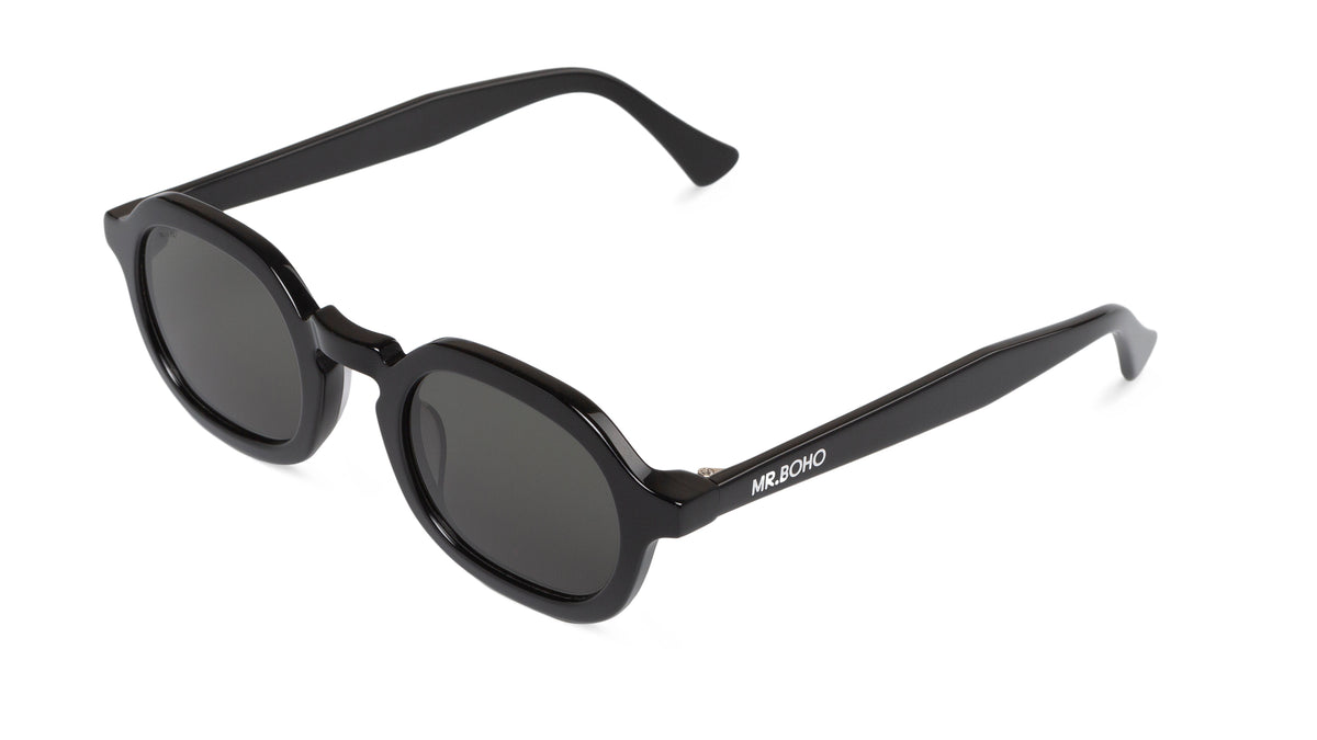 A pair of black-framed oval sunglasses with dark lenses - arial view