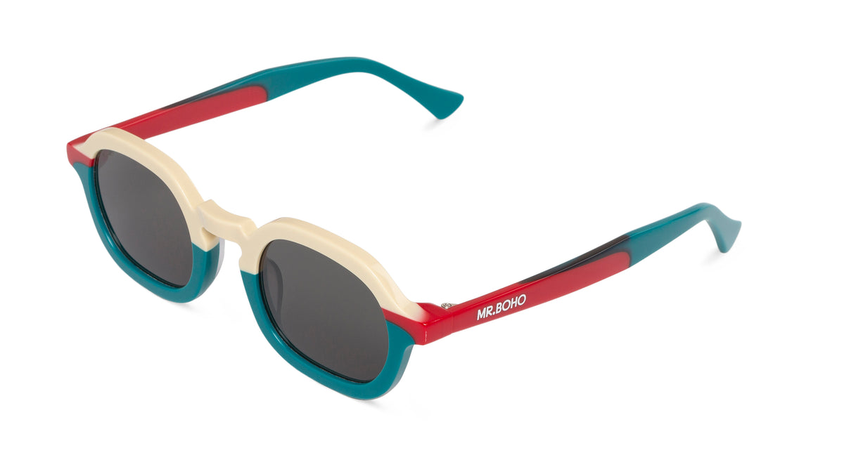 A pair of turquoise/white/red-framed oval sunglasses with dark lenses. - arial view