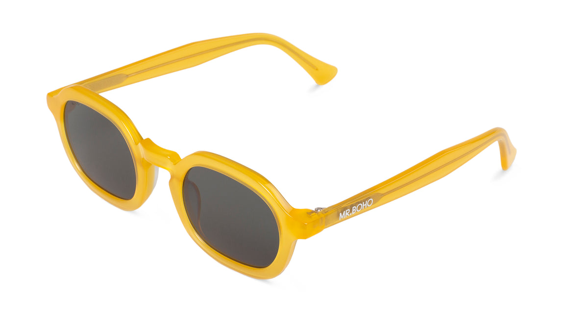 A pair of yellow-framed oval sunglasses with dark lenses.