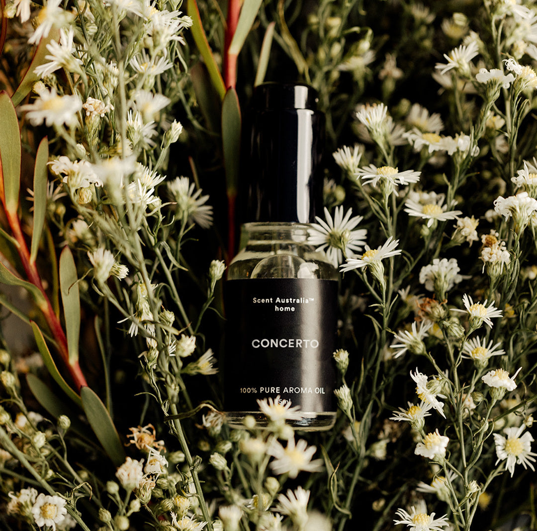 Concerto oil bottle in a bed of flowers
