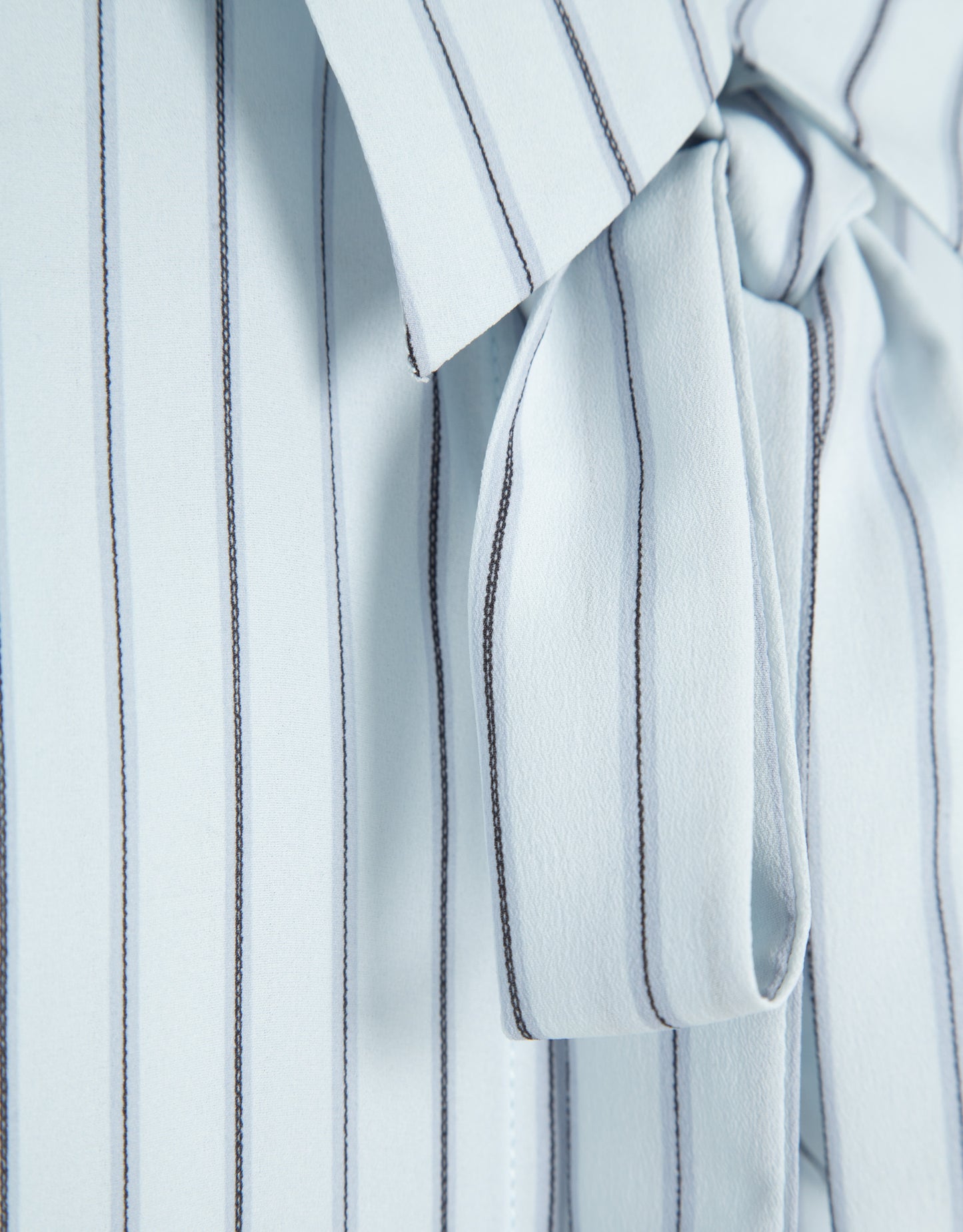 Blue striped shirt with bow at the neck