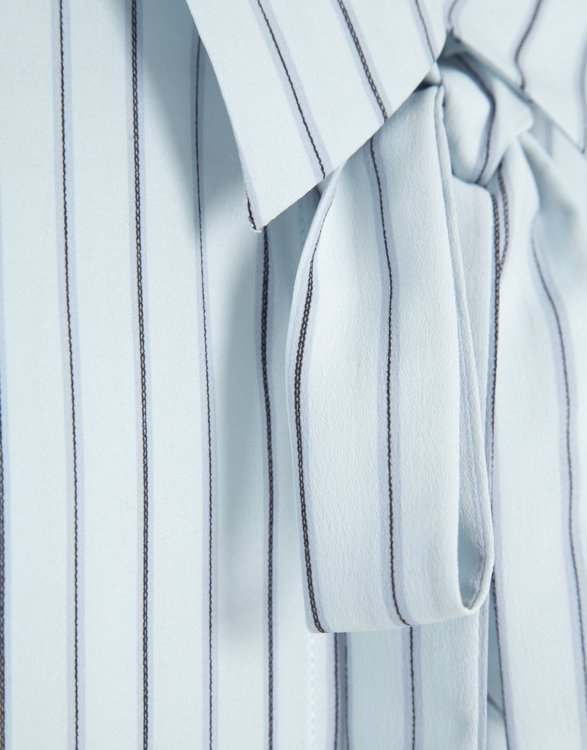 Blue striped shirt with bow at the neck