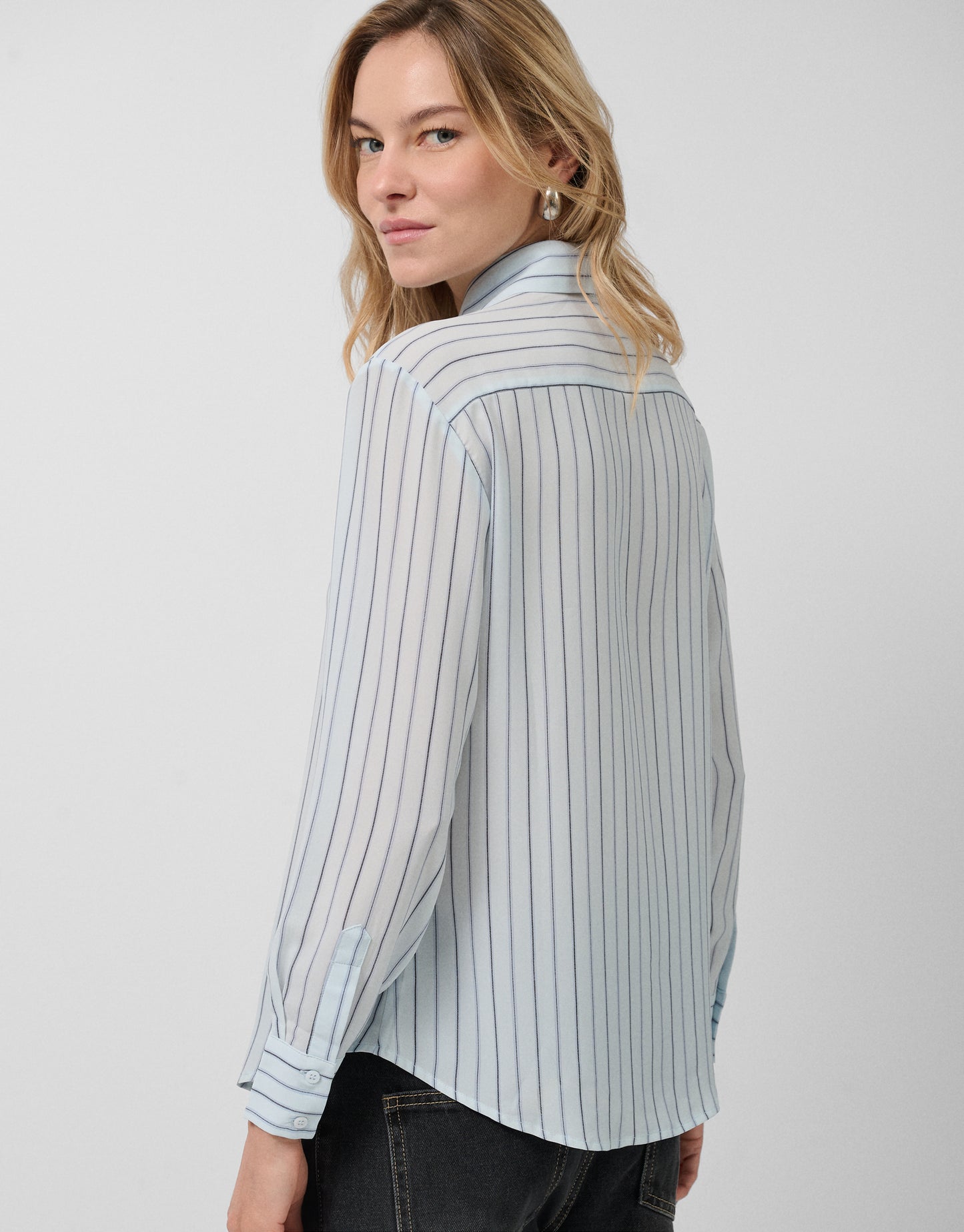 Blue striped shirt with bow at the neck