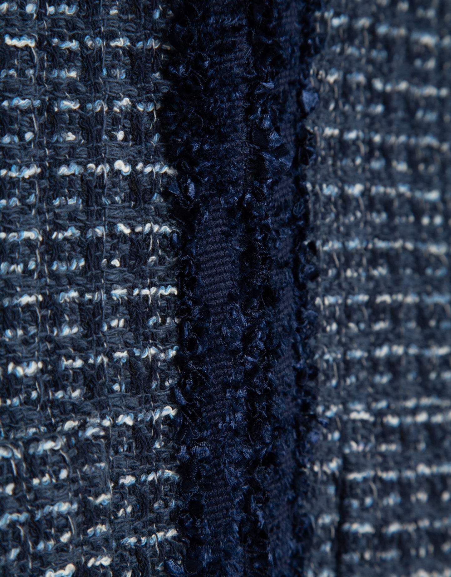 Short blue jacket with fringed trim on the front