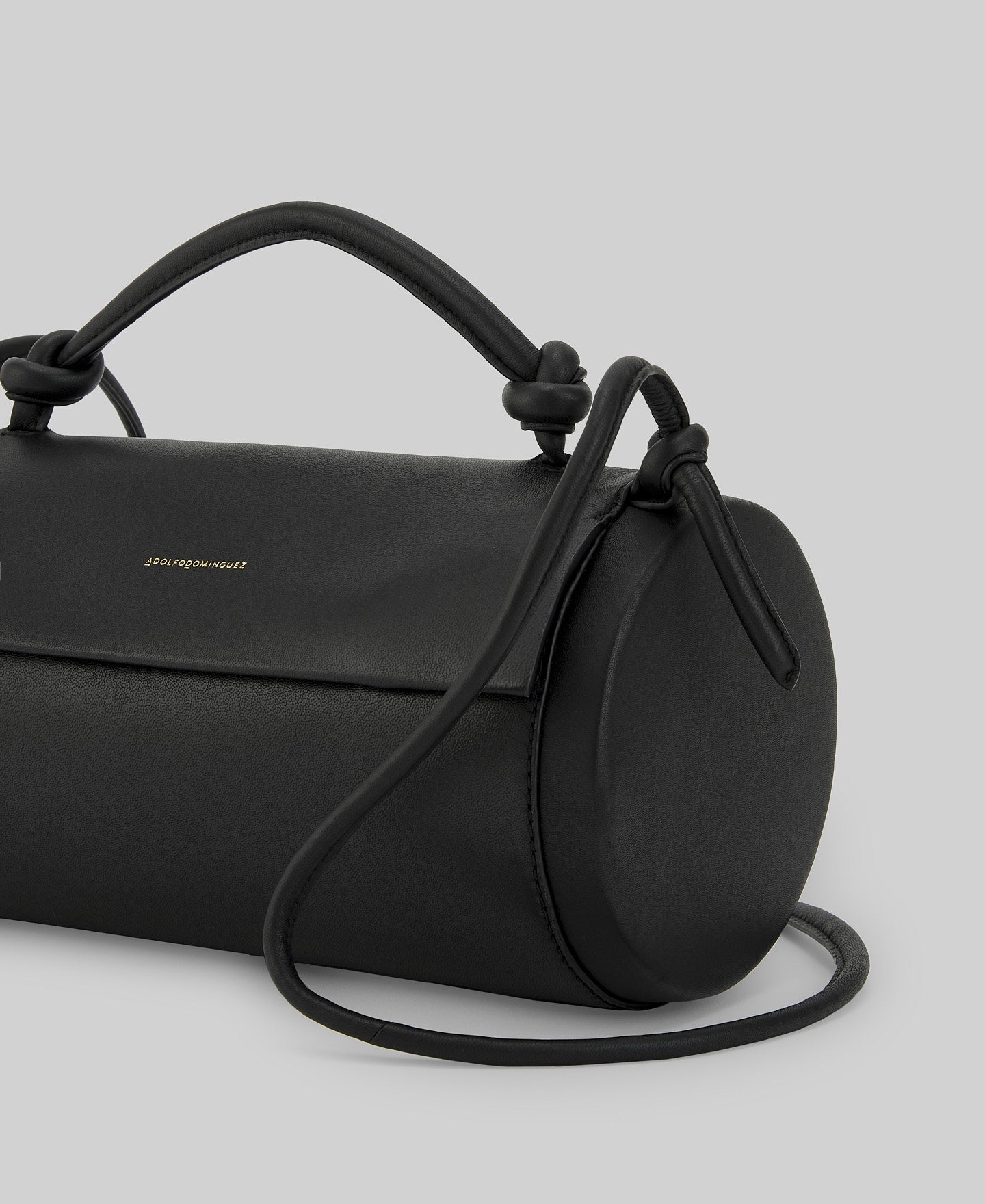 Black cylindrical leather bag woman in black