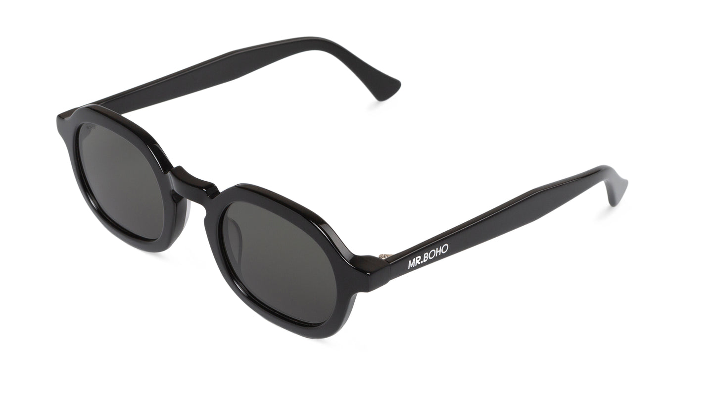 A pair of black-framed oval sunglasses with dark lenses - arial view