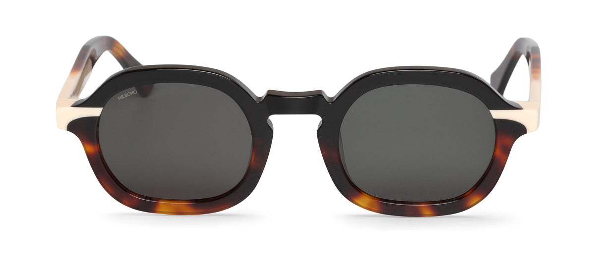 A pair of black and tortoiseshell framed oval sunglasses with dark lenses.
