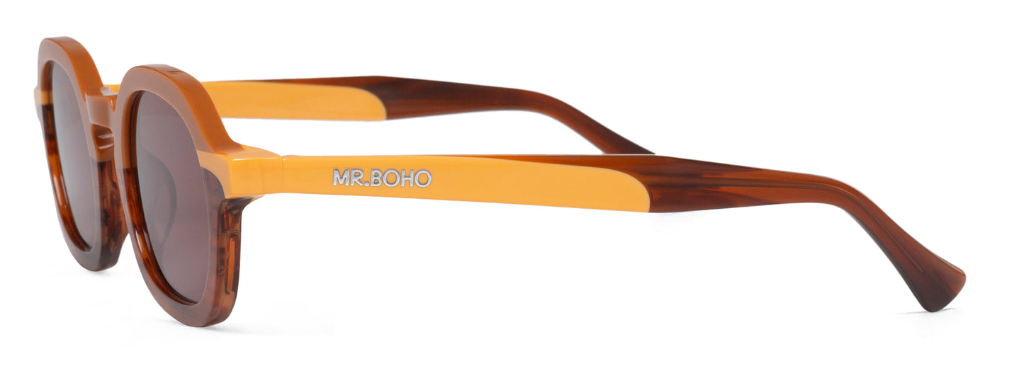A pair of brown-framed oval sunglasses with dark lenses. - side view with mr boho logo on arm