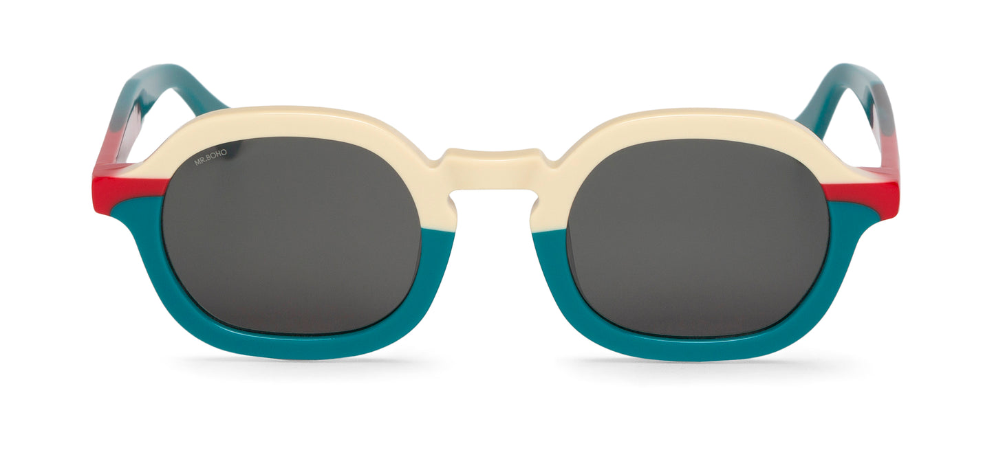 A pair of turquoise/white/red-framed oval sunglasses with dark lenses.
