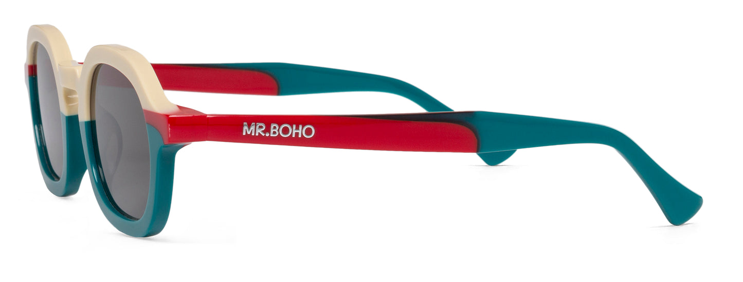 A pair of turquoise/white/red-framed oval sunglasses with dark lenses. - side view mr boho logo on arm