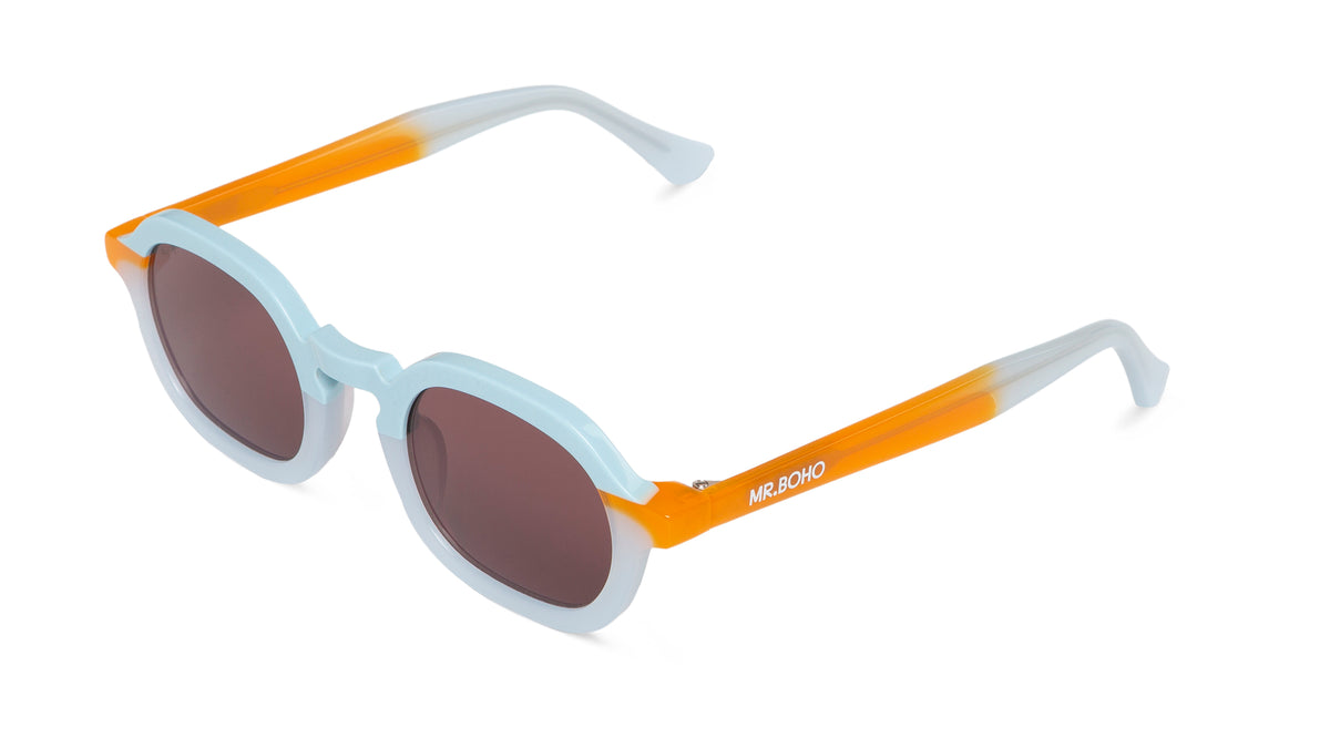 A pair of light blue with orange accents-framed oval sunglasses with dark lenses.-arial view