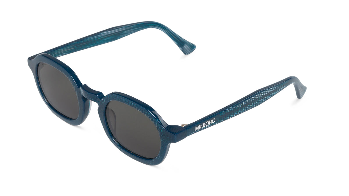 A pair of blue-framed oval sunglasses with dark lenses. - arial view