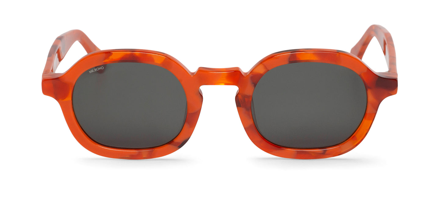 A pair of orange mosaic pattern-framed oval sunglasses with dark lenses.