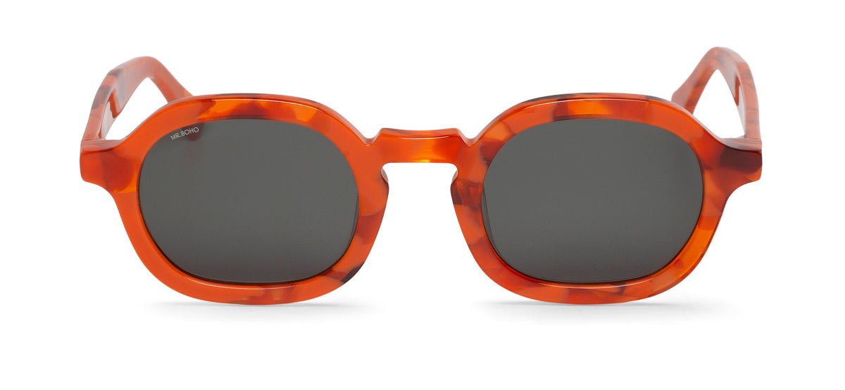 A pair of orange mosaic pattern-framed oval sunglasses with dark lenses.