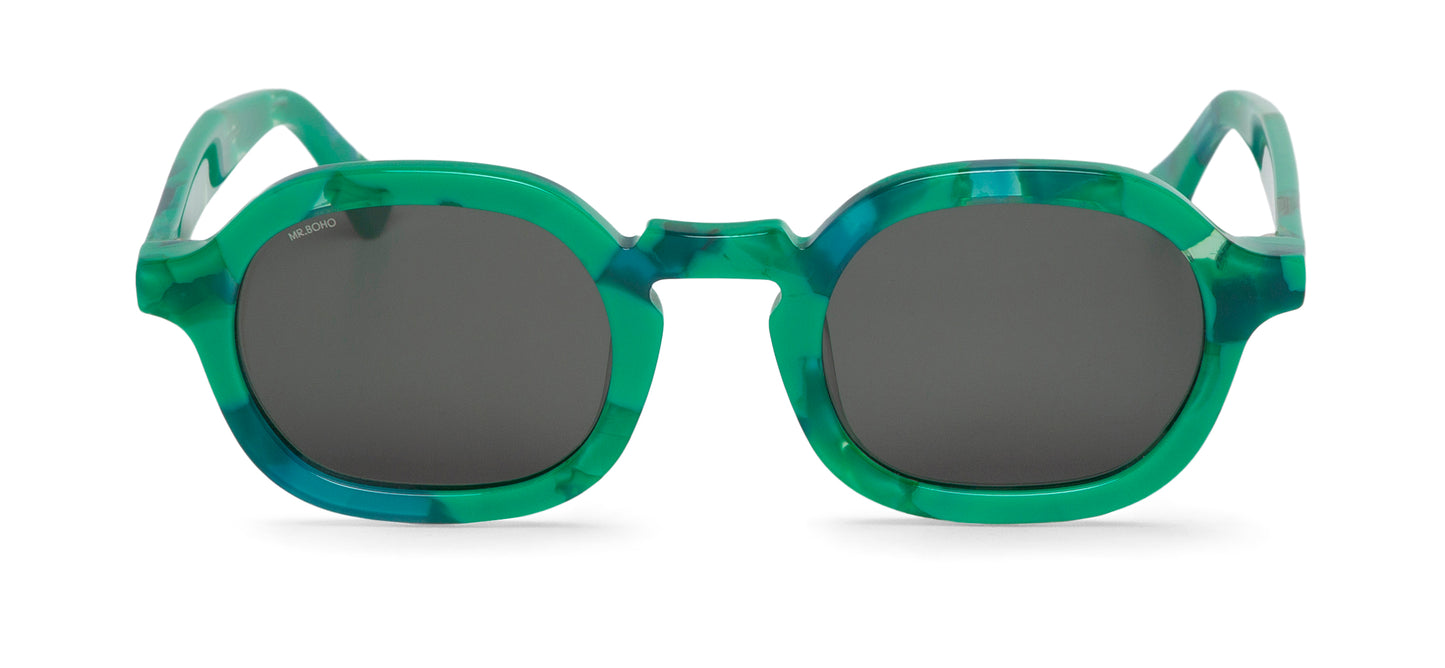 A pair of green mosaic pattern-framed oval sunglasses with dark lenses.