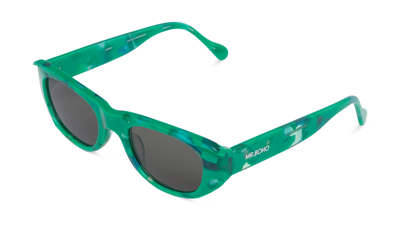 Rectangle with cat eye framed sunglasses in green mosaic pattern and dark lenses- arial view