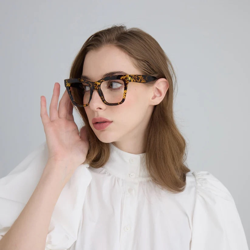 Woman wearing tortoiseshell effect square framed glasses with clear lenses