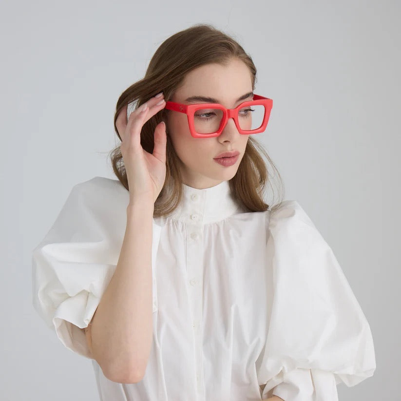 Woman wearing red square glasses