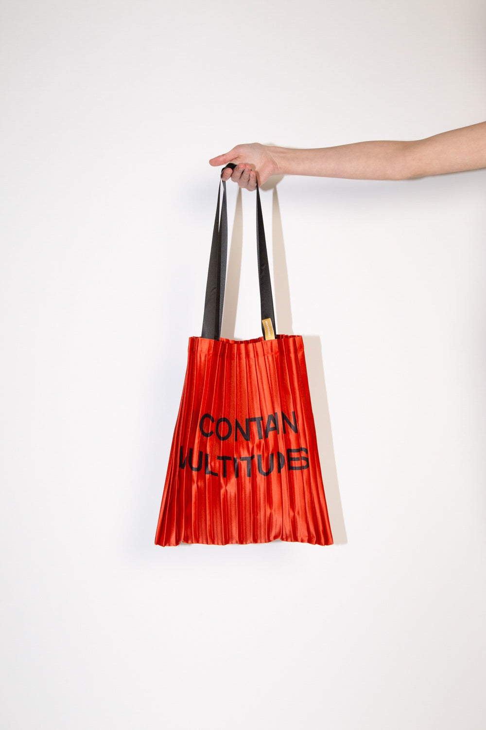 Multitudes Satin Pleated “I Contain” Red Tote Bag