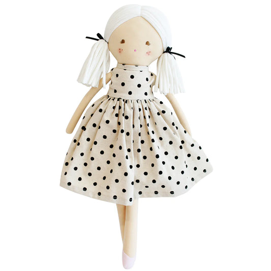plush doll with white pigtails and linen dress with black spots
