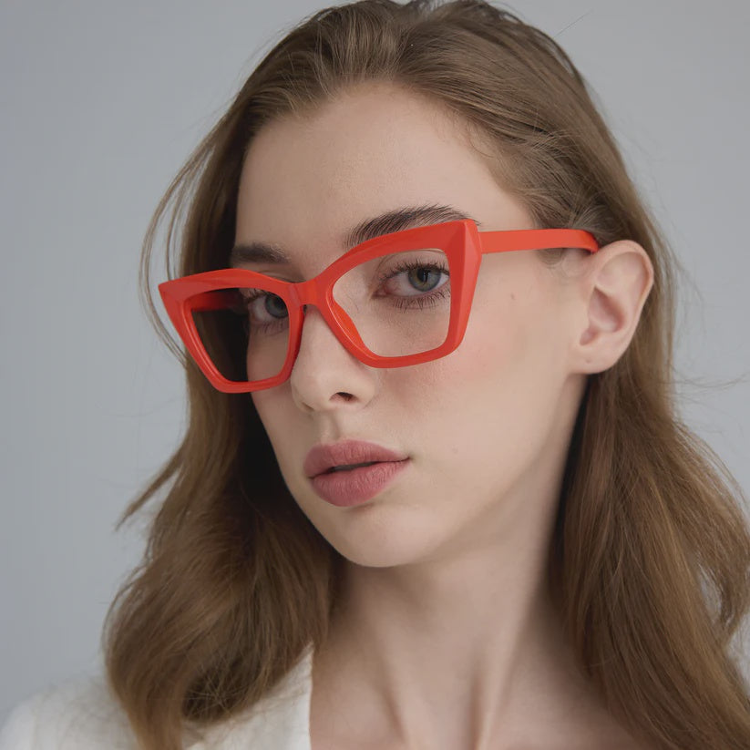 Woman wearing cat eye red framed glasses